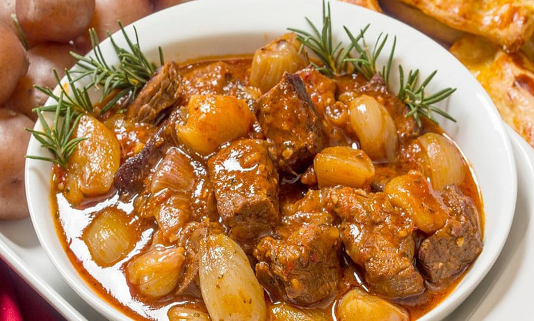 plate with ‘stifado’ means cooking meat with onions in tomato sauce and is the best food in Greece