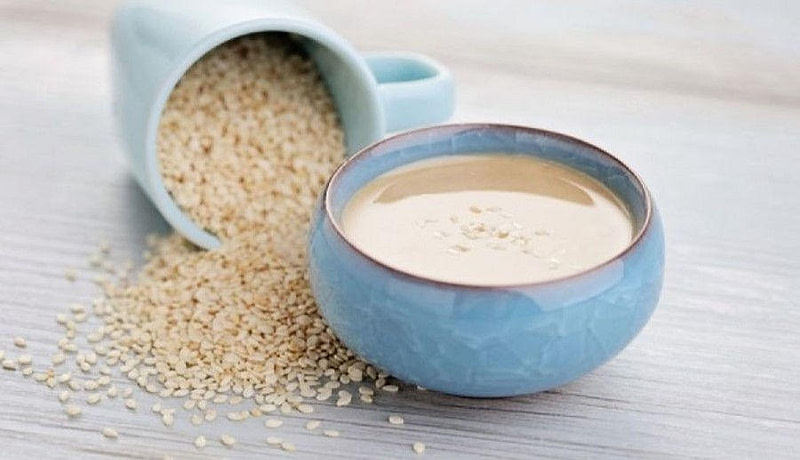 Close-up of a bowl with ‘tahini’ soup, a white oily paste made from sesame seeds
