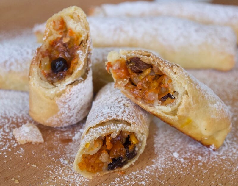 close-up of Greek ‘Kougkoulouari’, sweets with flaky pastry that is stuffed and wrapped in long packets, filled with rice, raisins