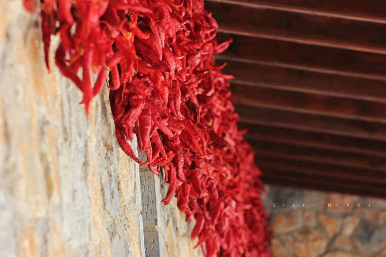 Florina peppers hanging from the wood ceiling for drying at 'Naoumidis All Peppers' outside