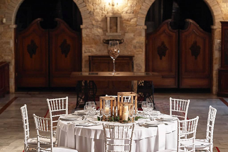 white table with plates and glasses front 'Kellari Papachristou' cellar