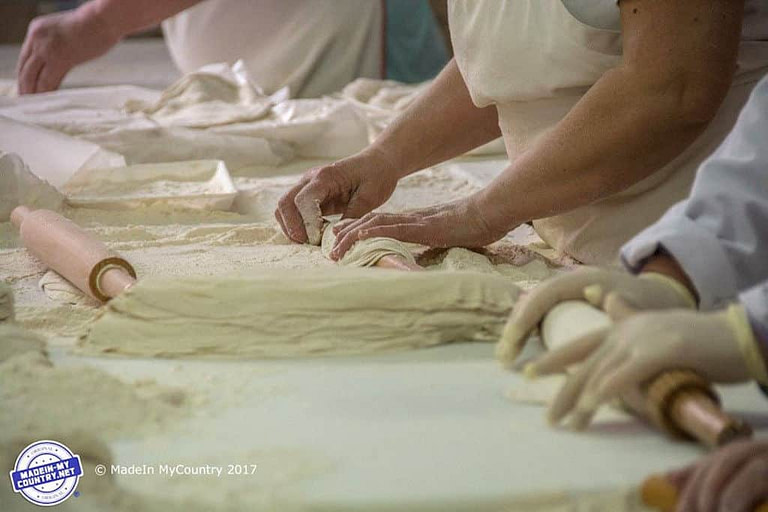 woman making dough at 'Evrogefsis' facilities