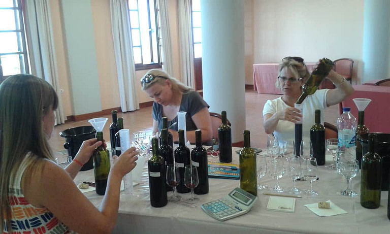 tourists creating a label for their wine bottle at 'Domaine Hatzimichalis' workshop