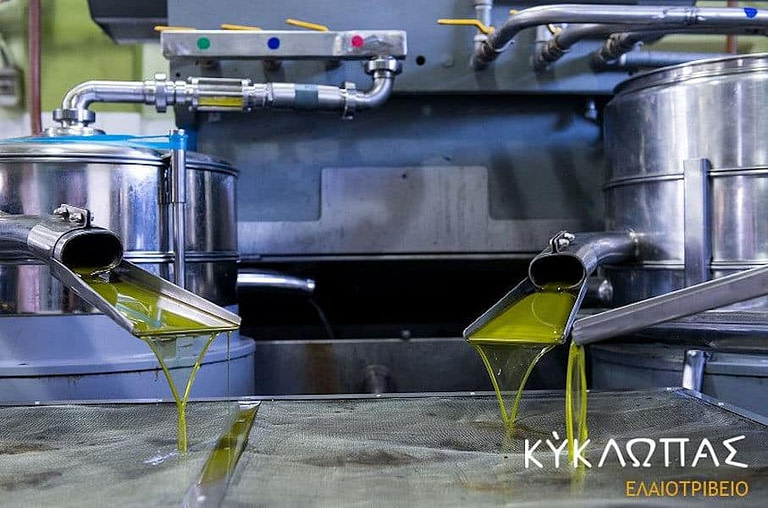 close-up of olive oil flowed from olive oil press machine at 'Kyklopas' plant