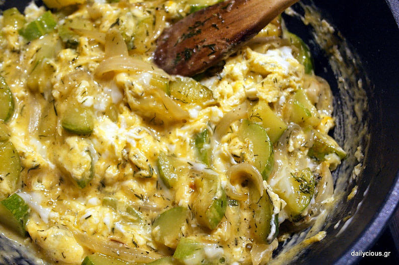 Close-up of ‘Tarachta’ is an omelet with peppers from Santorini, Greece and a wooden spoon mixing it