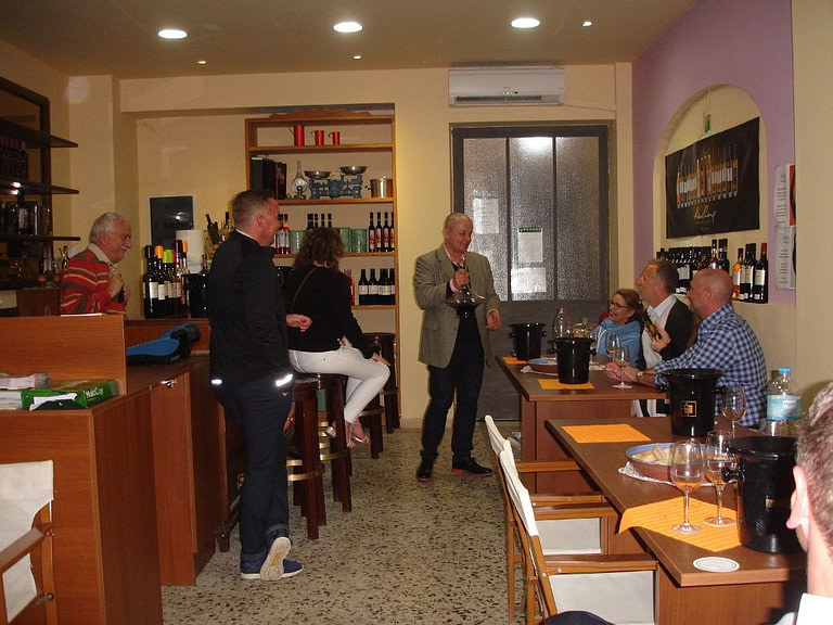 tourists tasting wines and listening to a guide at 'Domaine Foivos' winery