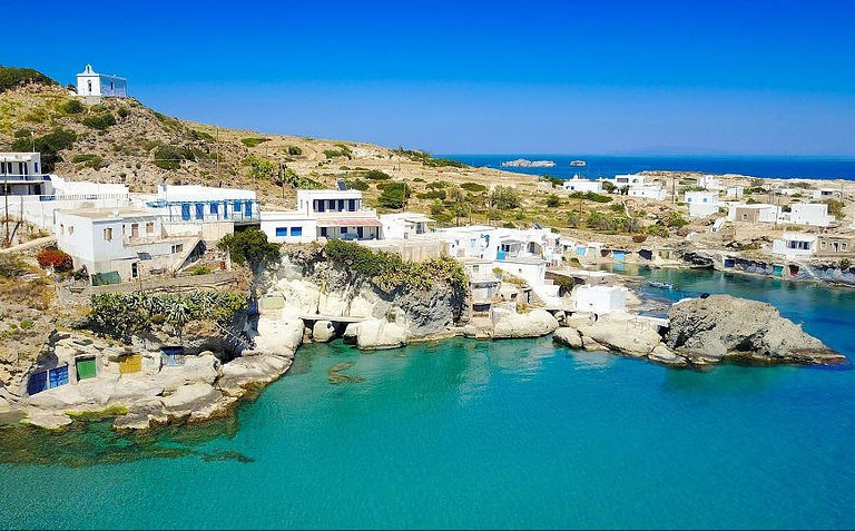 port with houses and The Telegraph: 14 Small Greek Islands to Visit after Lockdown
