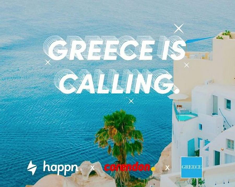 view from above of the sea and building that say greece is calling