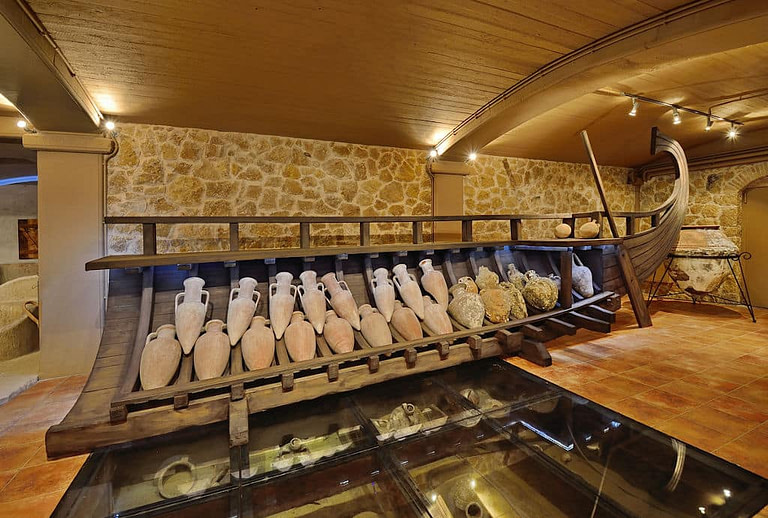 lying Greek wine ancient amphoras storage on wood stand at Wine Museum Costa Lazaridi