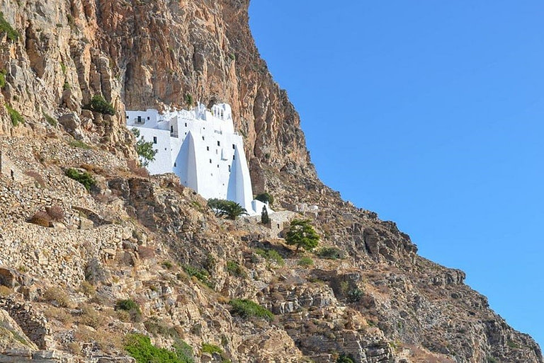 view of church surrounded by rocks at Amorgos that Sends Message of Optimism Through Gastronomy