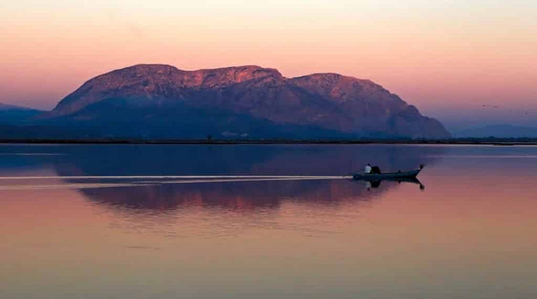 man with canoe on the lake enjoy sunset from tour Bottarga Stefos