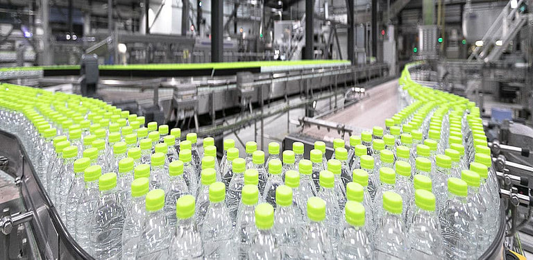Water bottling machine line with bottles at 'Dios Natural Mineral Water' factory