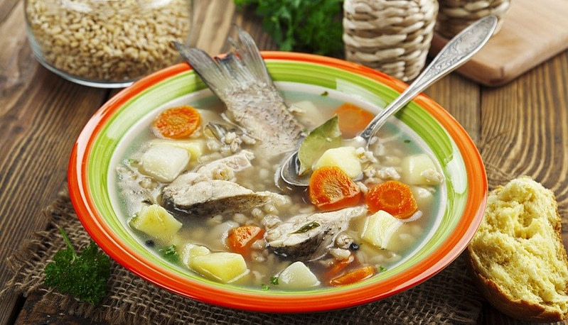 plate with Greek ‘Kakavia’ means soup with boiled onions, fish and carrots
